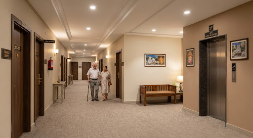 Clean, bright guest corridor outside rooms at Nandakam Rest House Tirumala
